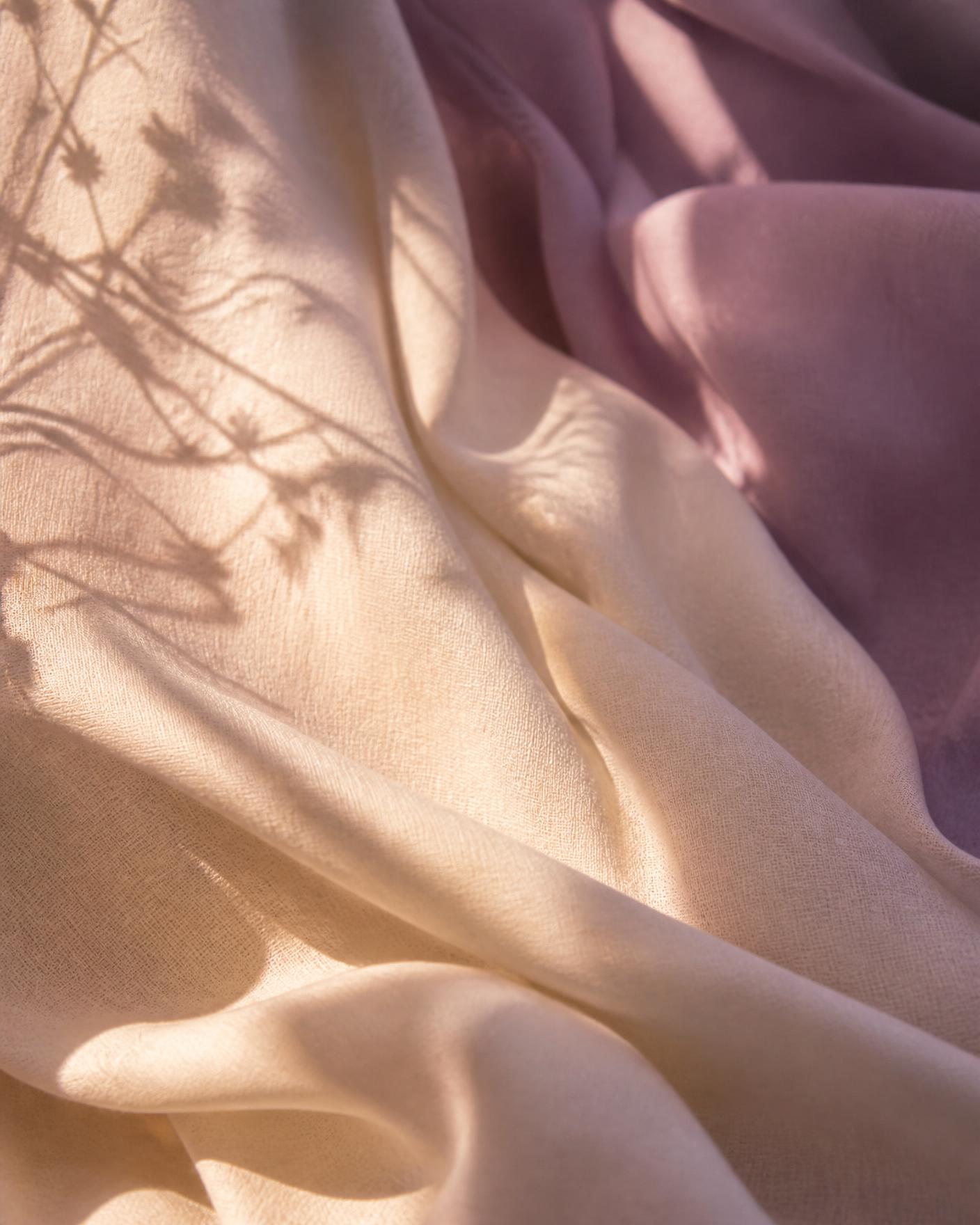 Soft folds of warm linen in cream and mauve light